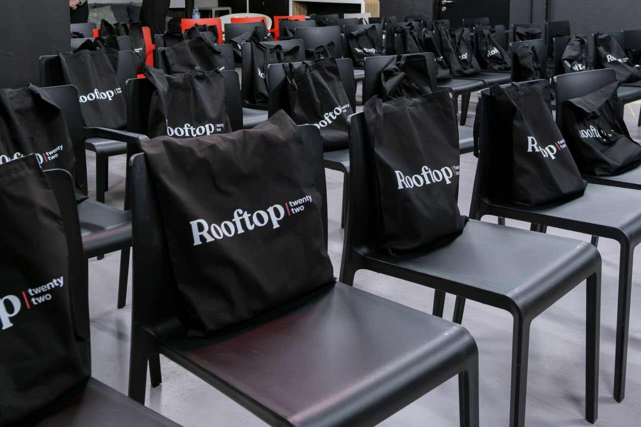 Rooftop Twenty Two tote bags laid out on the seats before Episode 01